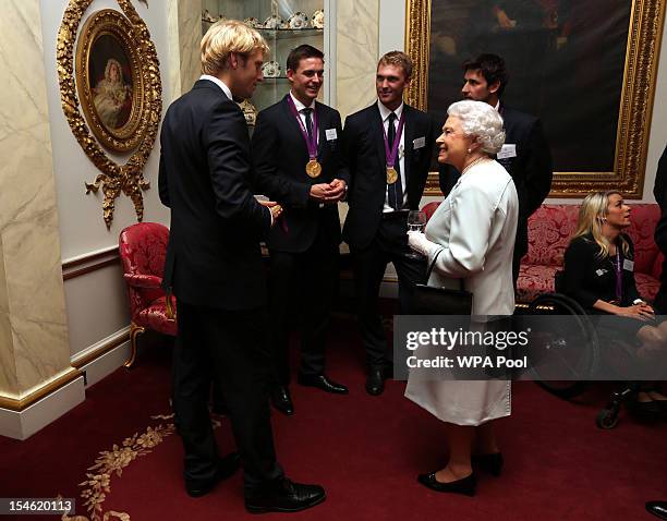 Queen Elizabeth II meets rowers Andrew Triggs-Hodge, Pete Reed, Alex Gregory and Tom James during a reception for the Team GB Olympic and Paralympic...