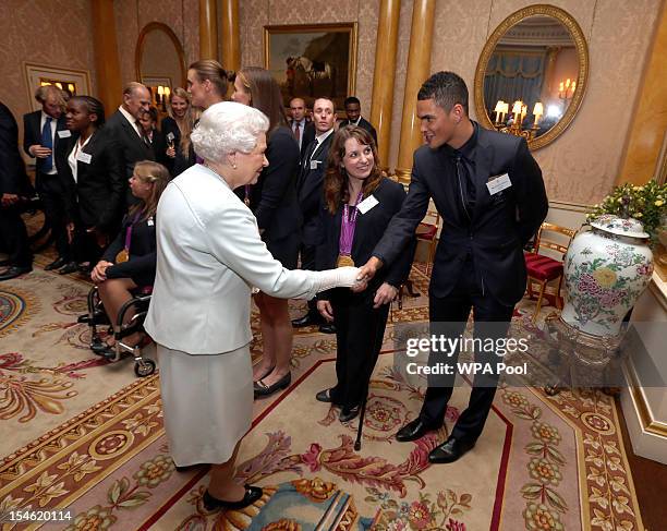 Queen Elizabeth II meets boxer Anthony Ogogo during a reception for the Team GB Olympic and Paralympic medalists at Buckingham Palace on October 23,...