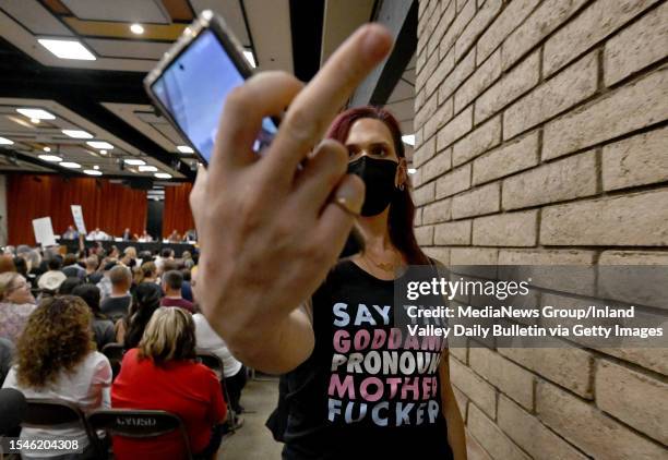 Gay and transgender students rights supporter gestures towards the camera during a Chino Valley Unified School District after being removed for...