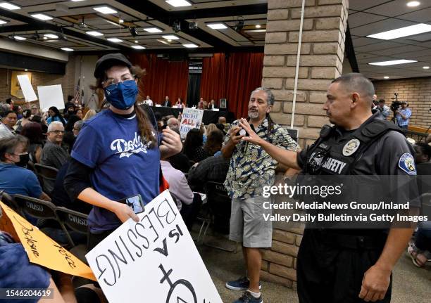 Gay and transgender students rights supporter is escorted out of a Chino Valley Unified School District board meeting for disrupting proceedings at...