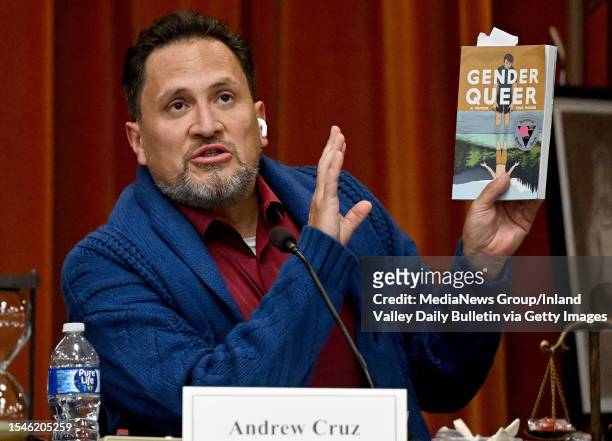 Chino Valley Unified School District clerk Andrew Cruz reads a passabe from the book Gender Queer during a heated public board meeting at Don Lugo...