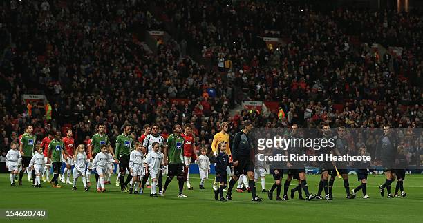 Mascots wearing Unite against Racism T-shirts walk out with the Match Officials and players prior to the UEFA Champions League Group H match between...