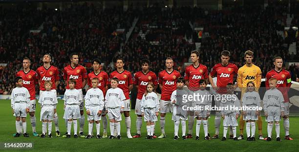 Mascots wearing Unite against Racism T-shirts pose with the Manchesyter United players prior to the UEFA Champions League Group H match between...