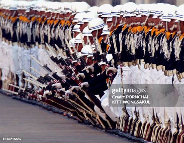 Thai soldiers perform at the royal plaza in Bangkok, 02 December 2002, as part of the celebration to commemorate King Bhumibol Adulyadej's 75th...