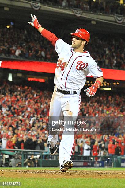 Bryce Harper of the Washington Nationals celebrates hitting a home run during Game Five of the National League Division Series against the St. Louis...