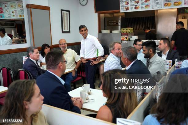 Britain's Prime Minister Rishi Sunak meets with Conservative party members and supporters at a cafe in Ruislip on July 21, 2023 after a by-election...