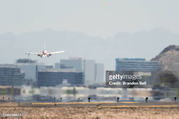 An airplane approaches the runway at the Phoenix Sky Harbor International Airport during a heat wave on July 15, 2023 in Phoenix, Arizona. Weather...