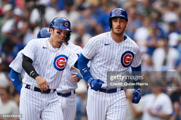 Seiya Suzuki congratulates Cody Bellinger of the Chicago Cubs for his grand slam home run in the third inning of the game against the Boston Red Sox...