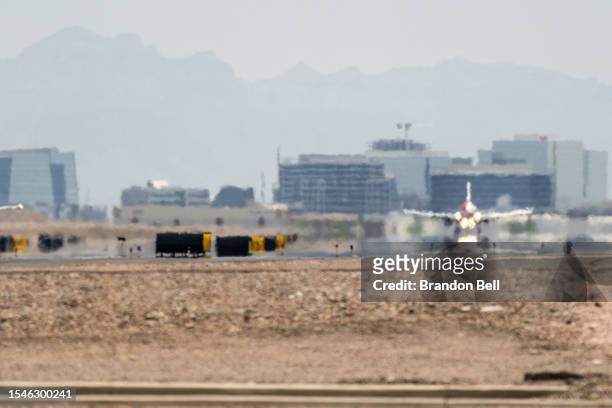 An airplane lands at the Phoenix Sky Harbor International Airport during a heat wave on July 15, 2023 in Phoenix, Arizona. Weather forecasts today...