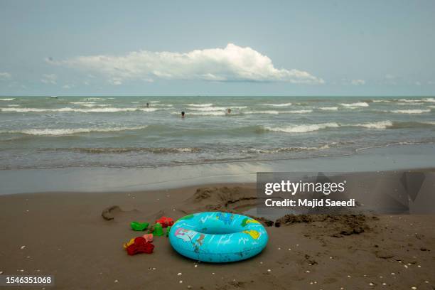 Iranian tourists play and bathe in the water on a shore of the Caspian sea in the city of Babolsar north of Tehran, on July 14, 2023 in Babolsar,...