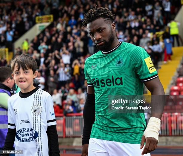 Allan Saint-Maximin of Newcastle United FC walks out with a mascotduring the Pre Season Friendly between Gateshead FC and Newcastle United at...