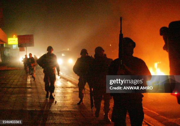 Lebanese soldiers stand guard at the site of a demonstration over power cuts in the mainly-Shiite southern suburbs of Beirut, 27 January 2008. At...