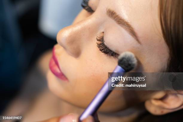professional makeup artist at work - eye make up stock pictures, royalty-free photos & images