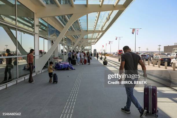 Man walks with a suitcase outside the newly-inaugurated terminal of Ercan airport outside Nicosia in the self-declared Turkish Republic of North...