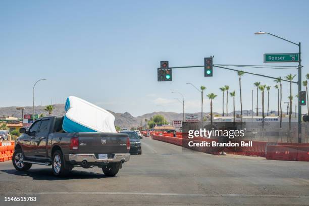Pickup truck transports an inflatable pool during a heat wave on July 15, 2023 in Phoenix, Arizona. Weather forecasts today are expecting...