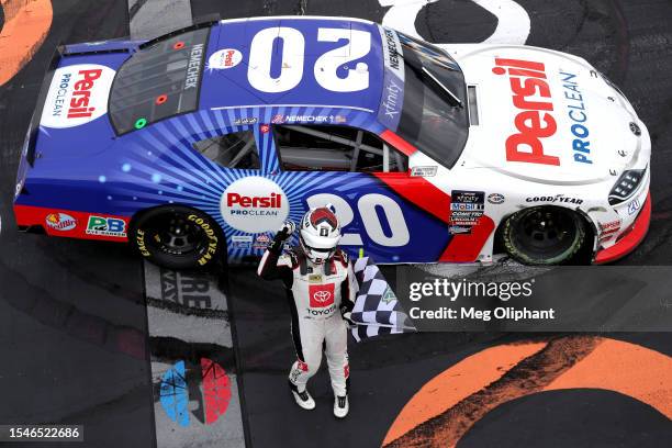 John Hunter Nemechek, driver of the Persil Toyota, celebrates with the checkered flag after winning the NASCAR Xfinity Series Ambetter Health 200 at...