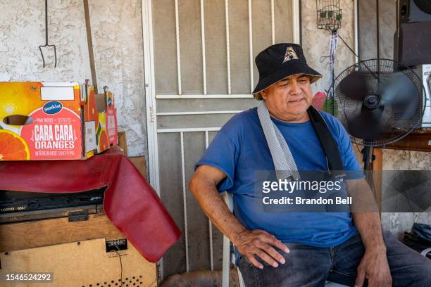 Richard Verduzco keeps cool on his porch ahead of his air conditioning unit installation during a heat wave on July 15, 2023 in Phoenix, Arizona....