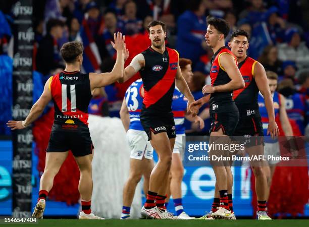 Kyle Langford of the Bombers celebrates a goal with teammates during the 2023 AFL Round 19 match between the Essendon Bombers and the Western...