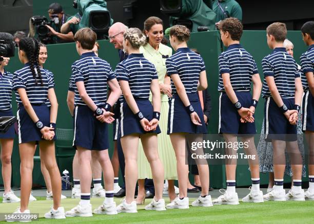 Catherine, Princess of Wales talks to the ball kids following the Women's Singles Final between Marketa Vondrousova of Czech Republic and Ons Jabeur...