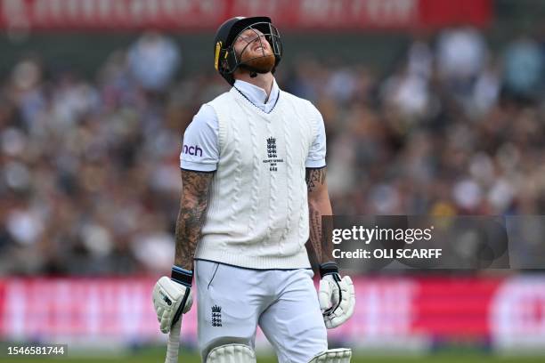 England's captain Ben Stokes reacts as he walks back to the pavilion after losing his wicket for 51 runs on day three of the fourth Ashes cricket...