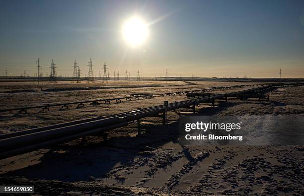 Pipelines stand in front of electricity pylons near OAO Gazprom's new Bovanenkovo deposit, a natural gas field near Bovanenkovskoye on the Yamal...