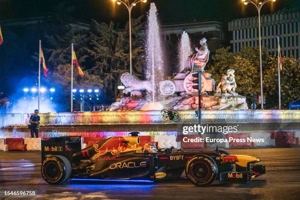 Driver Checo Perez drives the 'Red Bull RB7 ' single-seater around the urban route between Puerta de Alcala, the Metropolis building, Cibeles and a...