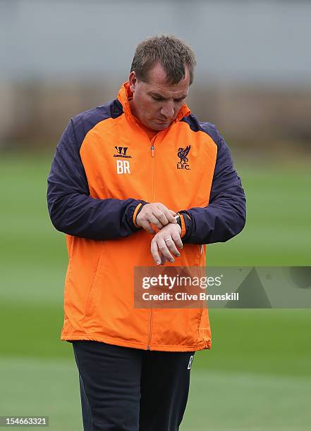 Liverpool manager Brendan Rodgers time keeping during a training session ahead of their UEFA Europa League group match against FC Anzhi Makhachkala...