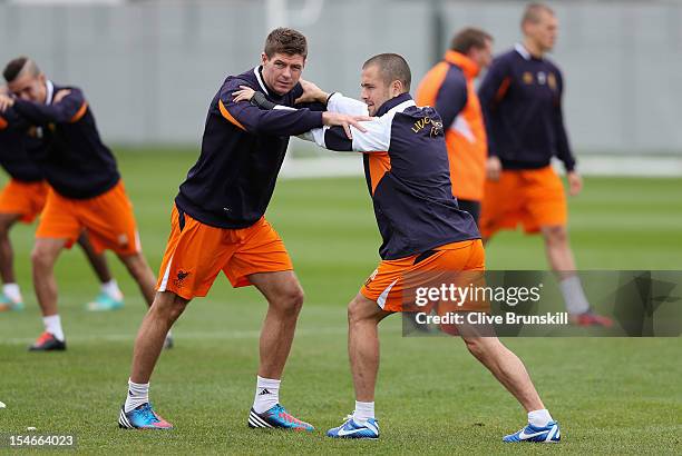 Steven Gerrard and Joe Cole of Liverpool stretch during a training session ahead of their UEFA Europa League group match against FC Anzhi Makhachkala...