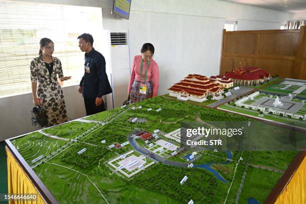 People look at models of the Maravijaya Buddha statue complex in Naypyidaw on July 21 ahead of its opening on August 2.