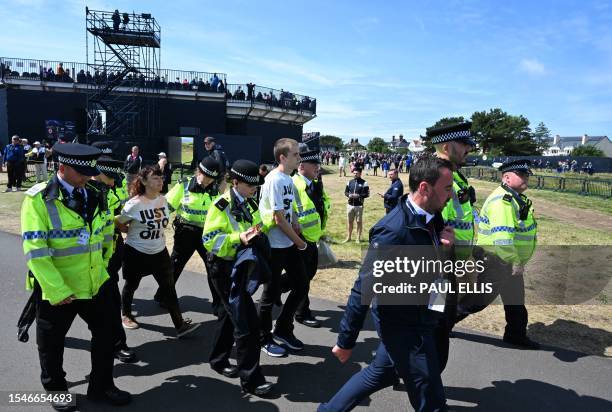 Police detain protestors from Just Stop Oil, by the 17th green on day two of the 151st British Open Golf Championship at Royal Liverpool Golf Course...