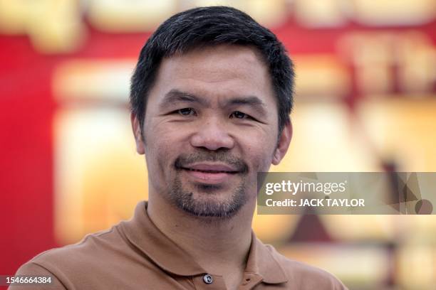 Filipino boxer Manny Pacquiao poses for photographs during a press conference in Bangkok on July 21 to promote his 2024 fight with Thai Muay Thai...