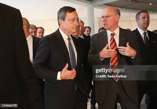 Mario Draghi , President of the European Central Bank , arrives with Bundestag President Norbert Lammert to speak to the media at the Bundestag after...