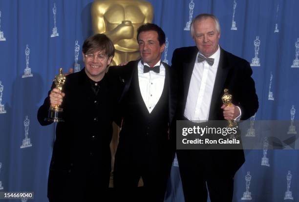 Musician Elton John, actor Sylvester Stallone and lyricist Tim Rice attend the 67th Annual Academy Awards on March 27, 1995 at Shrine Auditorium in...