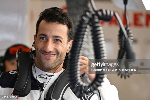 Alpha Tauri's Australian driver Daniel Ricciardo gets ready for the first practice session at the Hungaroring race track in Mogyorod near Budapest on...