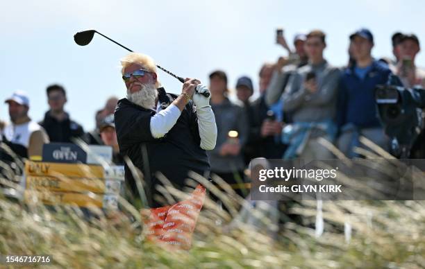 Golfer John Daly watches his drive from the 14th tee on day two of the 151st British Open Golf Championship at Royal Liverpool Golf Course in...