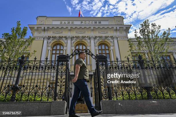 Man walks past the Bank of Russia headquarters in Moscow, Russia on July 21, 2023. After keeping the rate unchanged at 7.5% for the sixth consecutive...