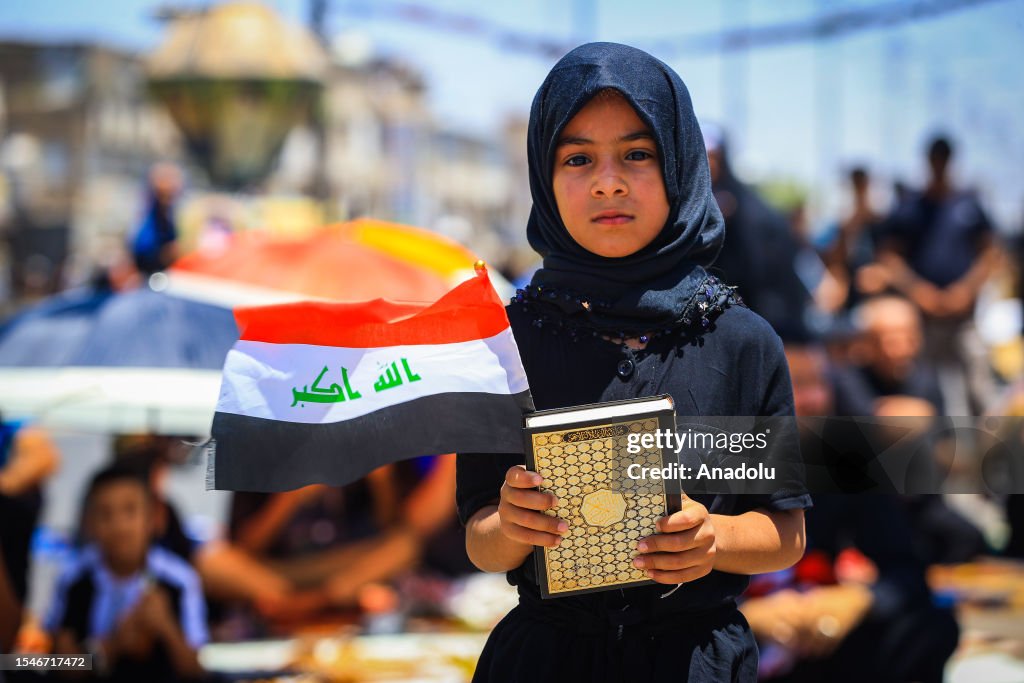 Muslims In Iraq A child holds Quran and flag of Iraq as the followers of Shia cleric ...