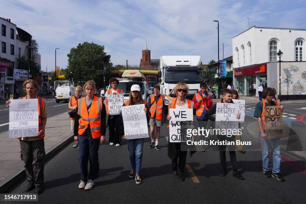 Just Stop Oil protesters slow walk in the road on the 21st of July 2023, London, United Kingdom. The group of young activists marched in Mile End...
