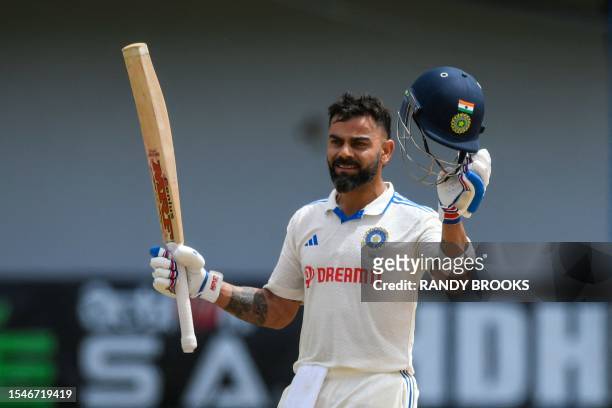 Virat Kohli of India celebrates his century during the second day of the second Test cricket match between India and West Indies at Queen's Park Oval...