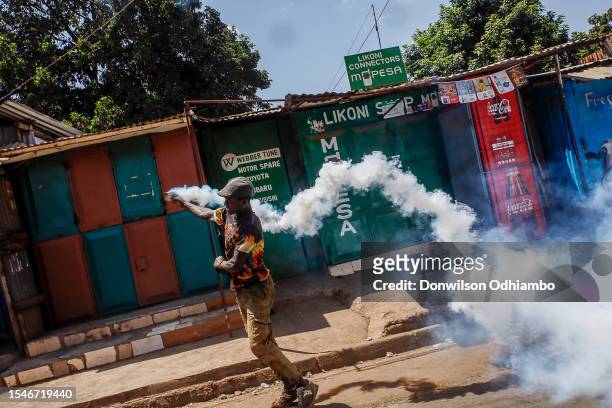 Protester sends a teargas canister back to the riot police during the Azimio la Umoja-One Kenya protest over high living cost on July 21, 2023 in...