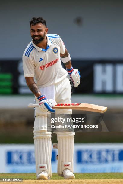 Virat Kohli of India celebrates his century during the second day of the second Test cricket match between India and West Indies at Queen's Park Oval...