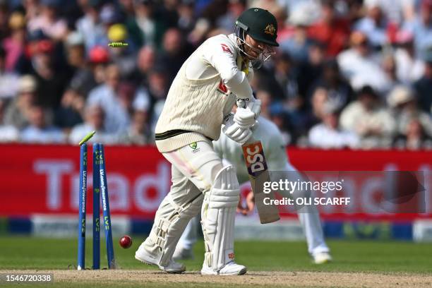 Australia's David Warner is bowled by England's Chris Woakes on day three of the fourth Ashes cricket Test match between England and Australia at Old...