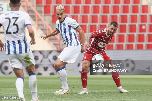 Hertha Berlin's Marc Oliver Kempf and Standard's Aron Donnum fight for the ball during a friendly soccer match between Standard de Liege and Hertha...