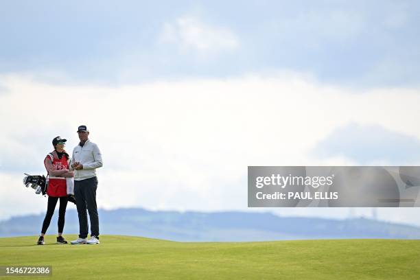 Golfer Stewart Cink talks to his caddie Lisa Cink on the 17th green on day two of the 151st British Open Golf Championship at Royal Liverpool Golf...