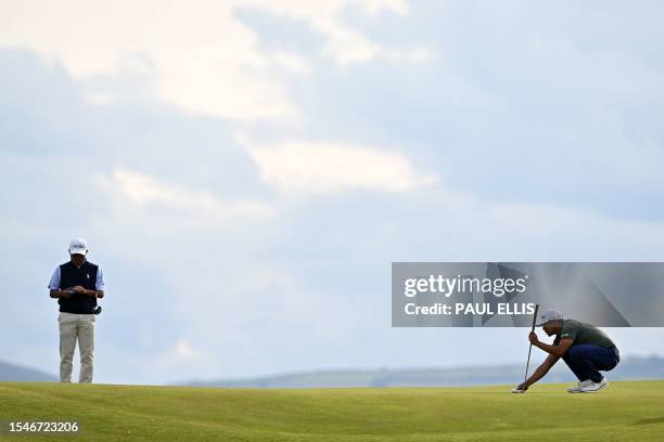 Japan's Takumi Kanaya and US golfer Kurt Kitayama stand on the 17th green on day two of the 151st British Open Golf Championship at Royal Liverpool...