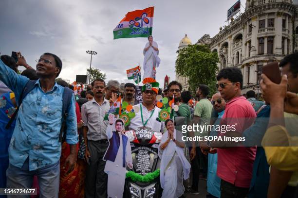 Trinamool Congress party supporter participates with a decorated scooter with party flags and banners in the Annual Martyrs Day program at the...