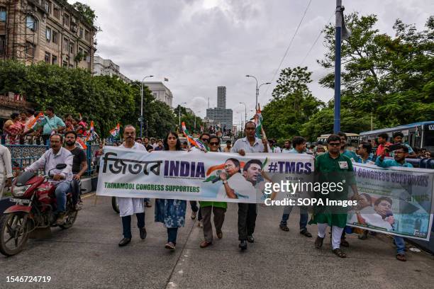 Trinamool Congress party supporters hold a banner of I.N.D.I.A , the 26 opposition parties in India during the Annual Martyrs Day program at the...