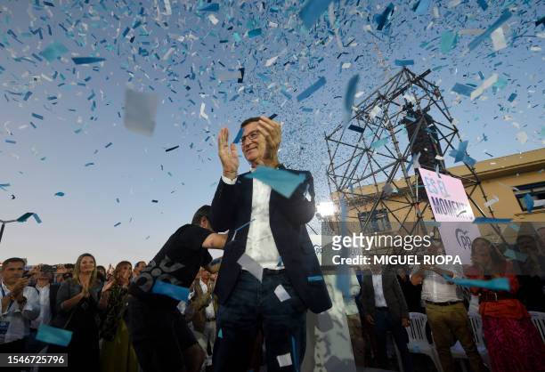 Spanish right-wing opposition party Partido Popular leader Alberto Nunez Feijoo applauds at the end of the PP campaign closing rally in A Coruna on...