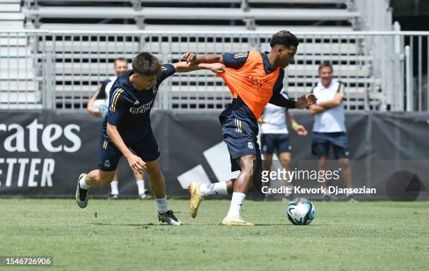 Rodrygo Goes of Real Madrid steals the ball from Arda Güler during training at UCLA Campus on July 21, 2023 in Los Angeles, California.