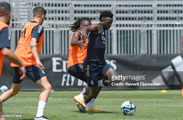 Vinicius Junior of Real Madrid is tackled by Eduardo Camavinga during training at UCLA Campus on July 21, 2023 in Los Angeles, California.